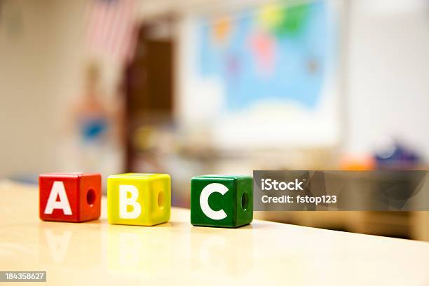 Letter Blocks On Table In Classroom Stock Photo - Download Image Now - Alphabet, Back to School, Block Shape