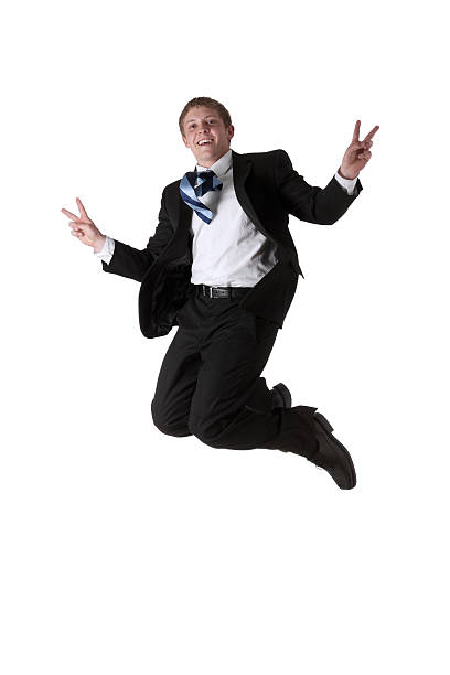 istock Businessman jumping showing victory sign 184358683