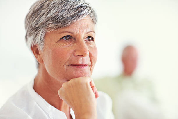 istock Thoughtful senior woman with blurred man 184358735