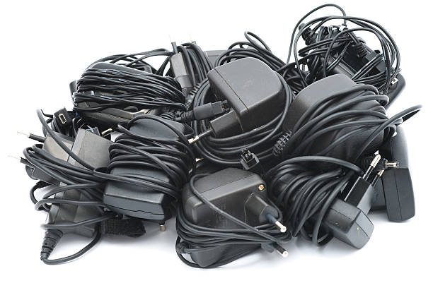 istock Old mobile phone chargers pile isolated on white 184358847