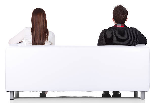 Rear view of a couple sitting on couch Rear view of a couple sitting on couchhttp://www.twodozendesign.info/i/1.png couch back stock pictures, royalty-free photos & images