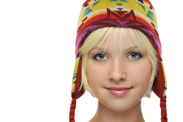 Young girl with cute colorful woolen hat Young girl wearing a cute colorful wool hat. late teens isolated on white one person cute stock pictures, royalty-free photos & images
