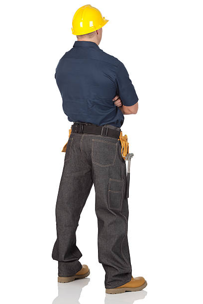 istock Rear view of a manual worker standing with arms crossed 184359472