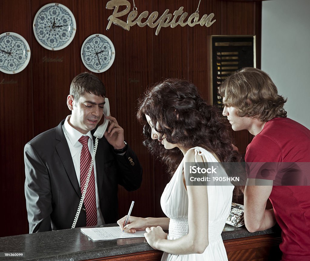 Hotel receptition Young coupe checking in at an hotel. Hotel Reception Stock Photo