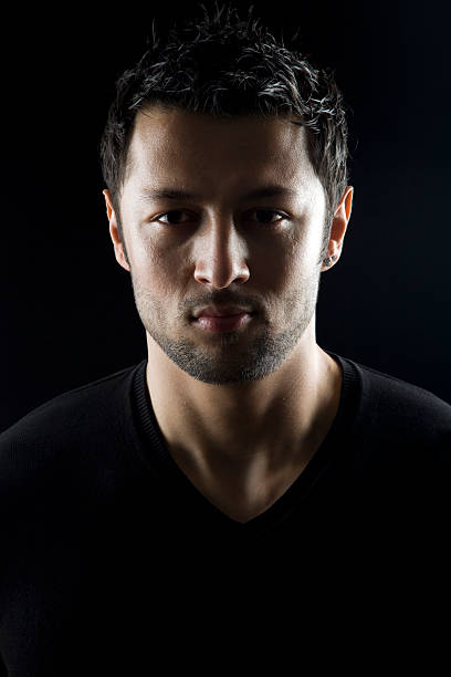 istock Portrait of man using black t-shirt on black background 184360444
