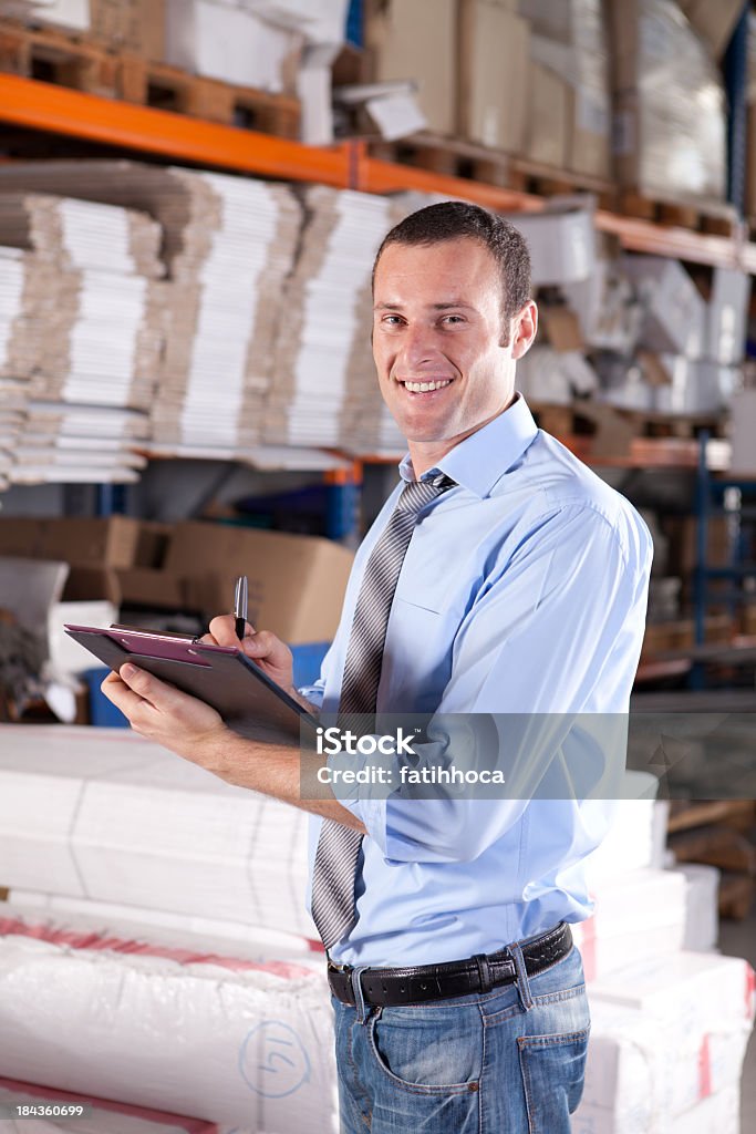 Young Warehouse Businessman Young businessman is working in warehouse. Businessman Stock Photo