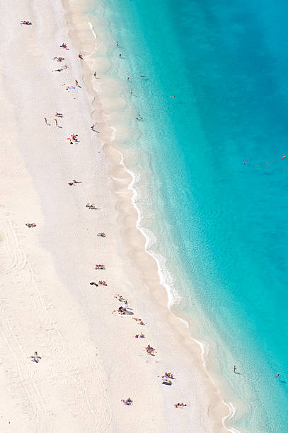 istock Bright Blue Mediterranean Beach with Sunbathers from Above 184360766