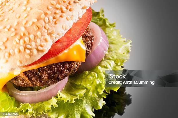 Cheeseburger With Onion Tomato And Lettuce Isolated On Black Stock Photo - Download Image Now