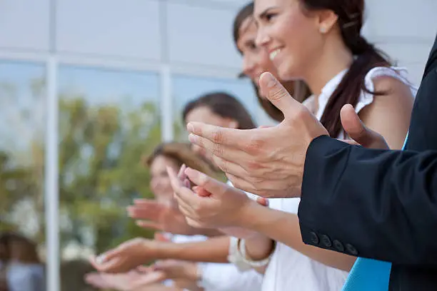 Photo of Happy business woman with colleagues applauding