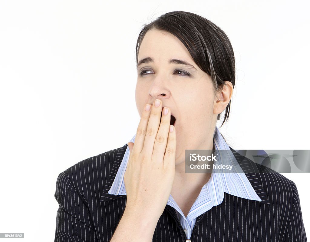 Over Doing It Business woman yawns on white background Adult Stock Photo