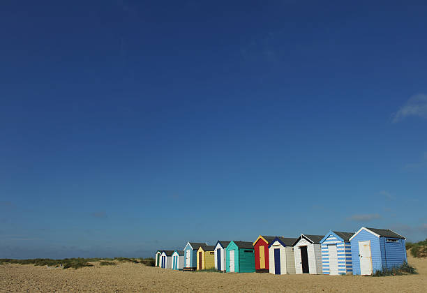 Beach Hut "Colourful beach huts amongst the sand dunes at Southwold with copy spaceSuffolk, England, UK" southwold stock pictures, royalty-free photos & images
