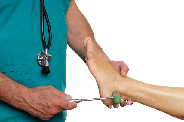 Doctor with Reflex Hammer Doctor with reflex hammer examining feet reflexes rubber mallet stock pictures, royalty-free photos & images