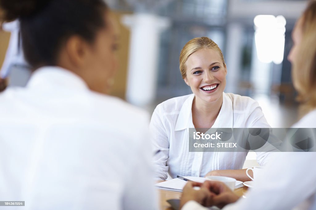 Business woman in a meeting with executives Portrait of charming business woman in a meeting with other executives at office 20-29 Years Stock Photo