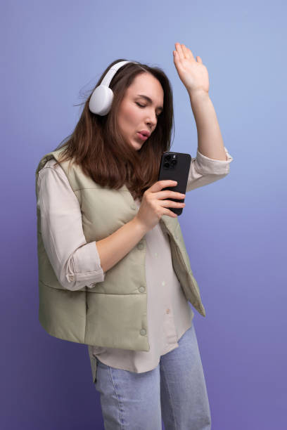 istock positive 30s lady with wireless headphones is having a blast on studio background 1843620876