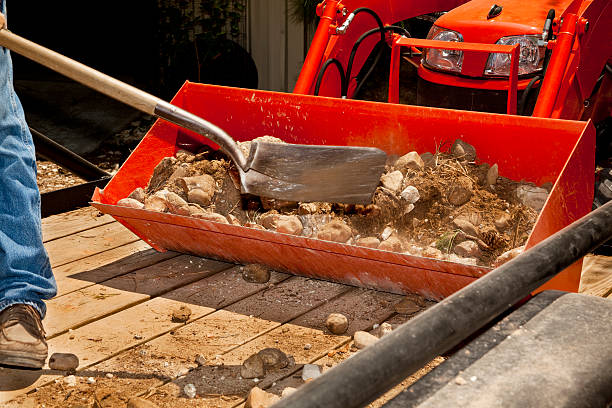 istock Man shoveling rock into tractor bucket 184362229