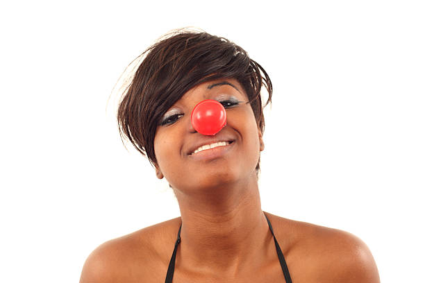 istock African woman wearing a clown nose 184362497