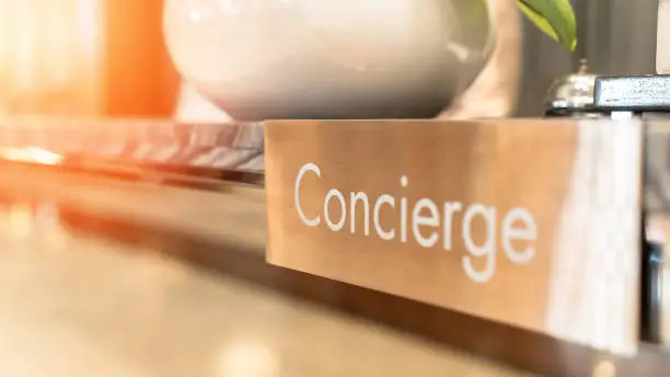 Concierge service, reception desk counter at frontdesk of hotel with hospitality staff team working for tourist business customer