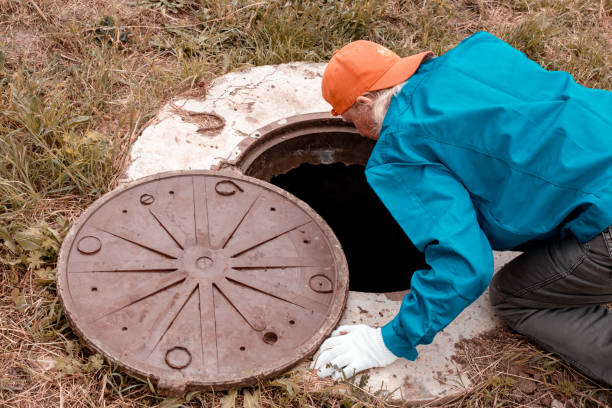 istock A worker leaned over the well to check the water meter. Plumbing work in rural areas 1843629875