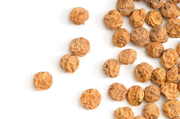 Tigernuts(Chufa) scattered across a white background.
