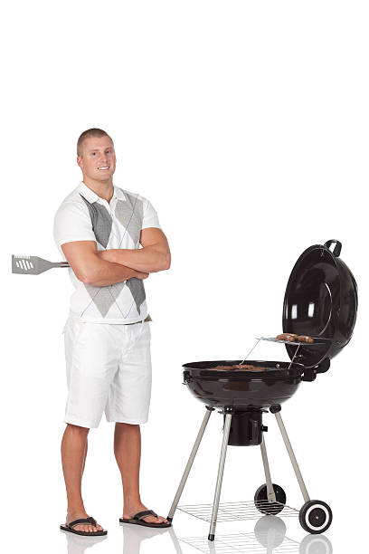 istock Man standing near a barbecue grill preparing food 184363505