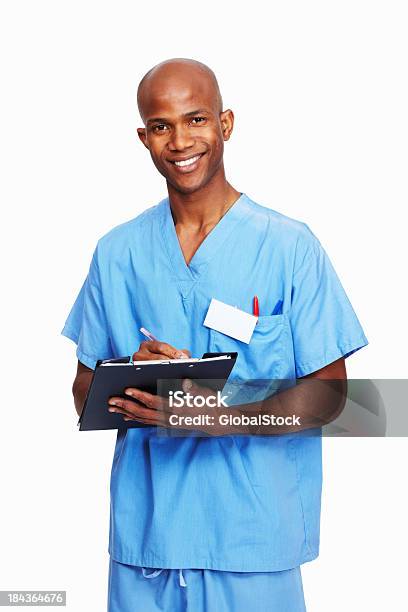 Doctor Writing On Clipboard Foto de stock y más banco de imágenes de 30-39 años - 30-39 años, Adulto, Adulto joven