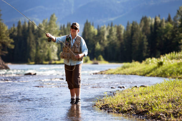 istock Man fly fishing on a mountain river side 184364719