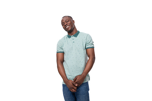 young happy positive short haired american man dressed in mint summer t-shirt on white background.
