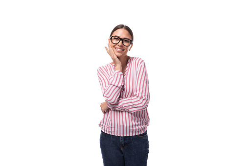 young positive secretary woman in glasses is dressed in a red-white blouse on a white background.