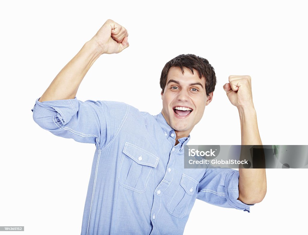 Male celebrating success Portrait of happy male celebrating success with clenched fist on white background 20-29 Years Stock Photo