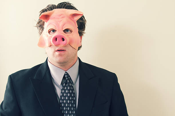 бизнес человек маска свиньи - pig greed business mask стоковые фото и изображения