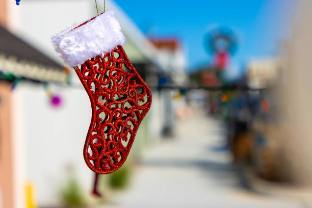 Closeup of a generic sign reading Merry Christmas on a red and white stocking symbolizing the Christmas Season.