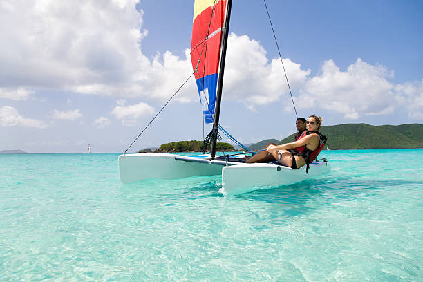 couple sailing a catamaran in the Caribbean
