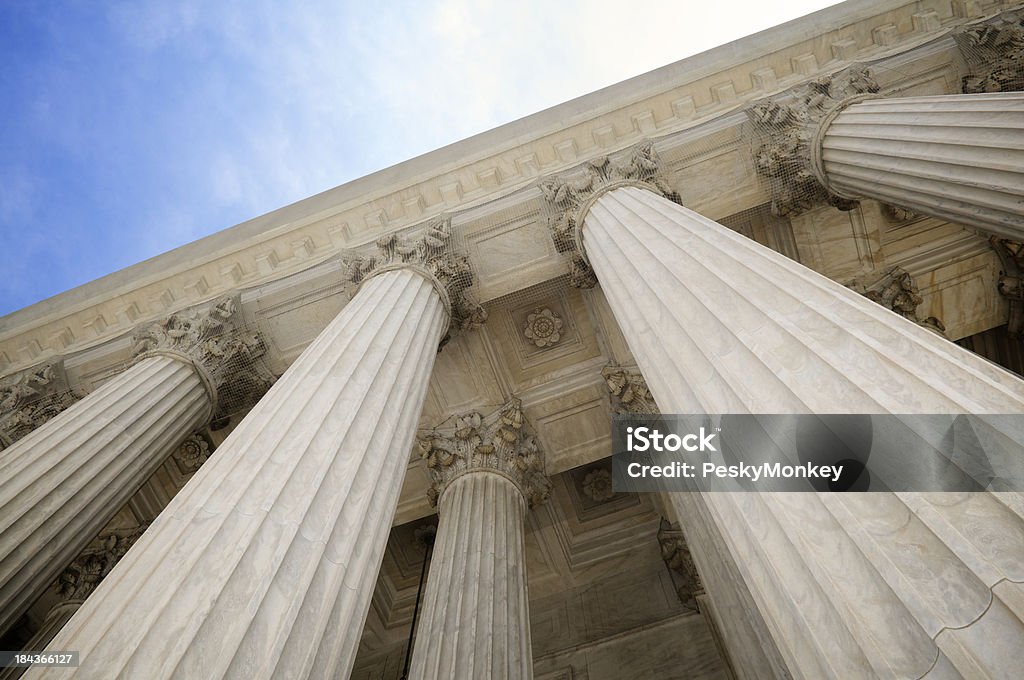 Grand Stone Columns of USA Supreme Court Building Washington DC Grand classical stone columns soar up to decorative entablature at the Supreme Court building Courthouse Stock Photo