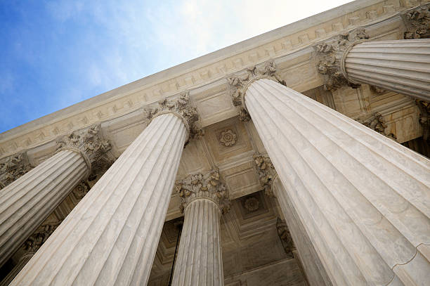Grand Stone Columns of USA Supreme Court Building Washington DC Grand classical stone columns soar up to decorative entablature at the Supreme Court building classical greek photos stock pictures, royalty-free photos & images