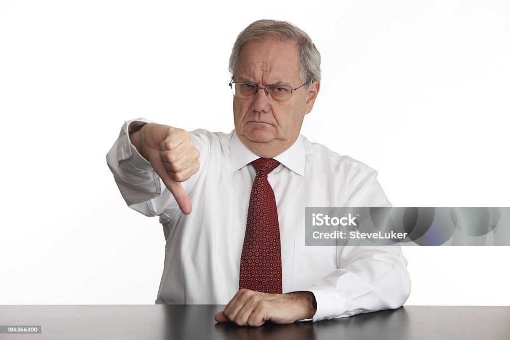 Thumbs Down Unhappy businessman showing his disapproval. Grumpy Old Man Stock Photo