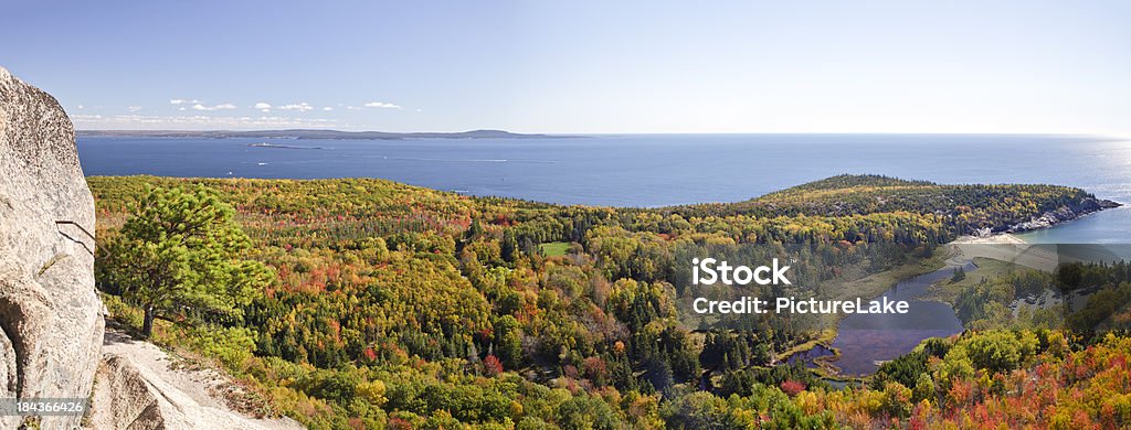 Beehive Autumn colors and Sand Beach panorama, Acadia A panorama from the rung trail of The Beehive with brilliant fall colors. Sand Beach and Great Head are in the mid foreground, with Egg Rock and Schoodic Peninsula in the far background. Acadia National Park Stock Photo