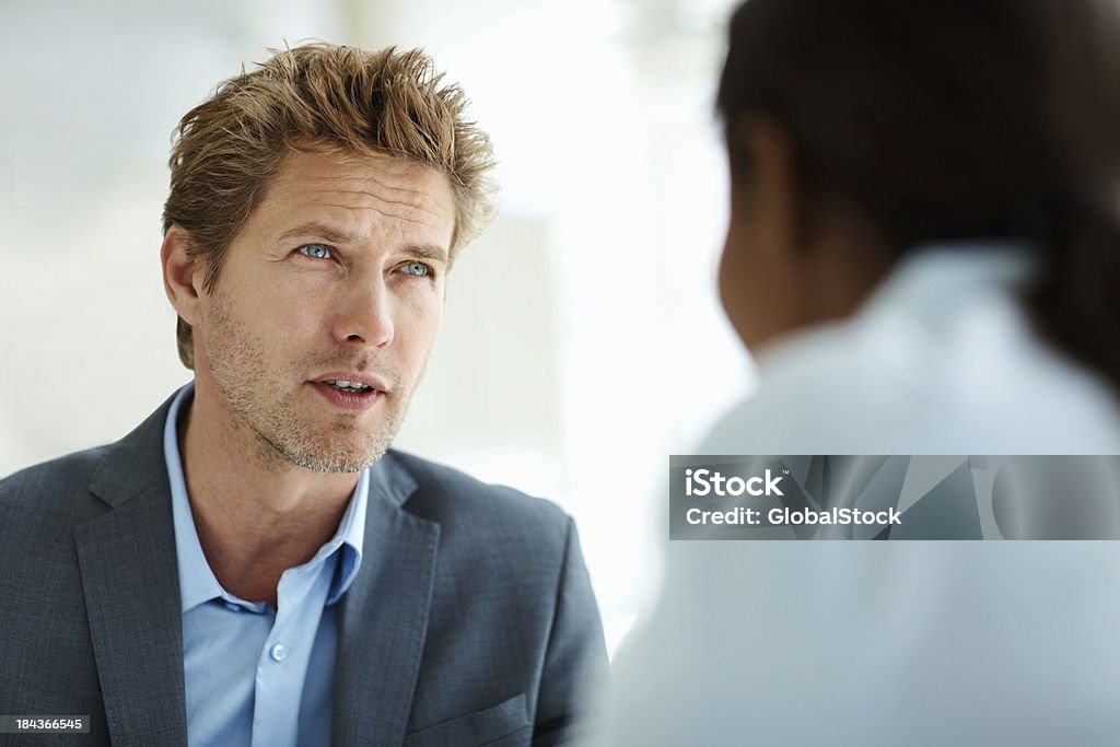 Business man conversing with female coworker "Portrait of handsome, young business man conversing with colleague" 30-39 Years Stock Photo