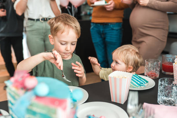 istock Two little brothers indulging in delicious cake 1843665686
