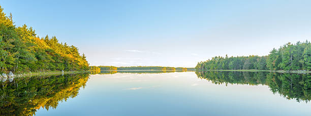 Panorama of autumn lake just before sunset stock photo