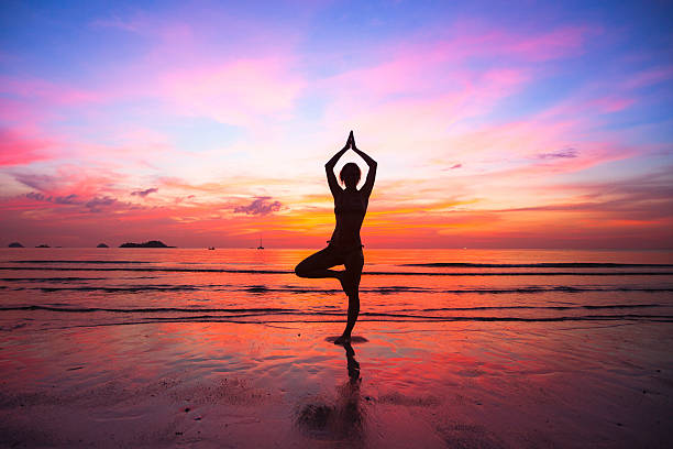 istock Silhouette woman yoga practice at the seaside. 184369480