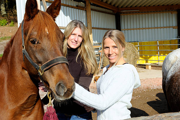 istock Two Young Women and a Horse 184369750