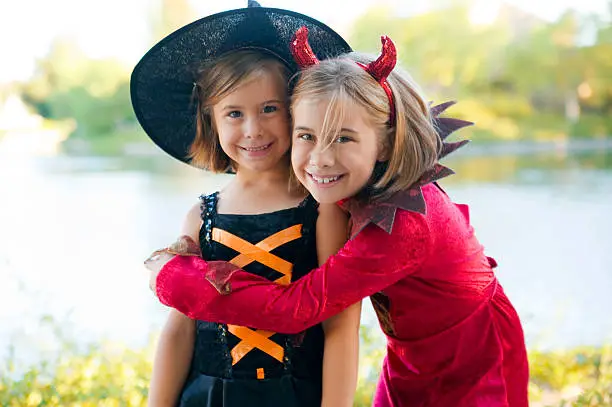 Two cute girls in their Halloween costumes.