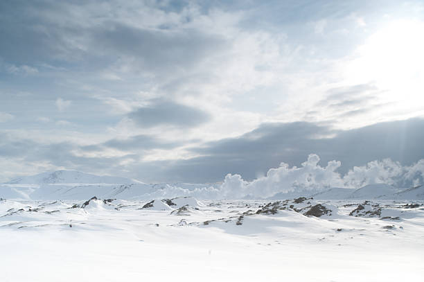 Iceland snowscape scenery with steam rising in distance stock photo