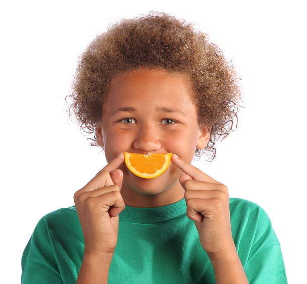 istock African American Boy with Orange Slice Smile 184371220