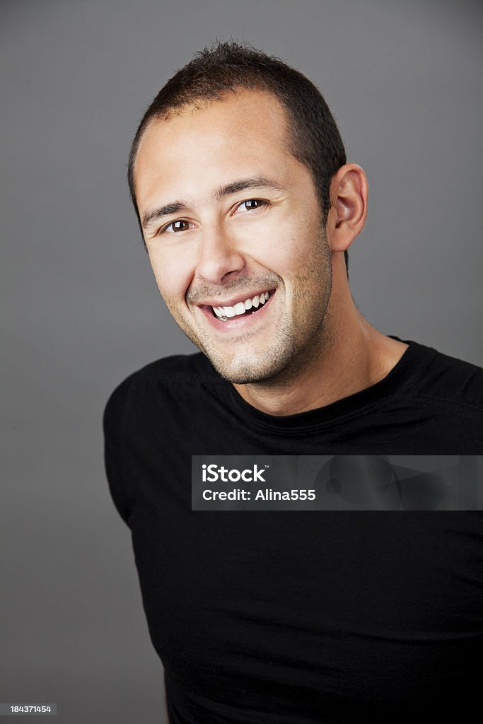 Real people: studio portrait of handsome man in late 20s Real people: studio portrait of happy handsome man in his late 20s on grey background. You might also be interested in these: 20-29 Years Stock Photo