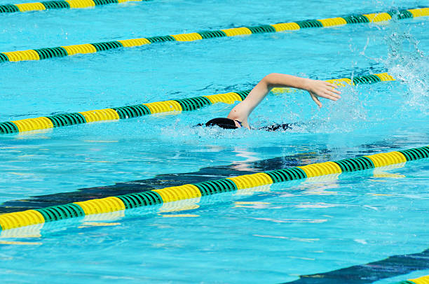 istock Young Girl Athlete Freestyle Front Crawl Swimmer Racing in Pool 184372003