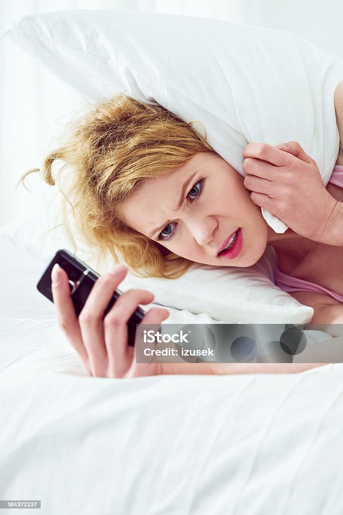 Wake up to late Shocked young adult woman checking time on cell phone and noticing that wake up to late. 25-29 Years Stock Photo