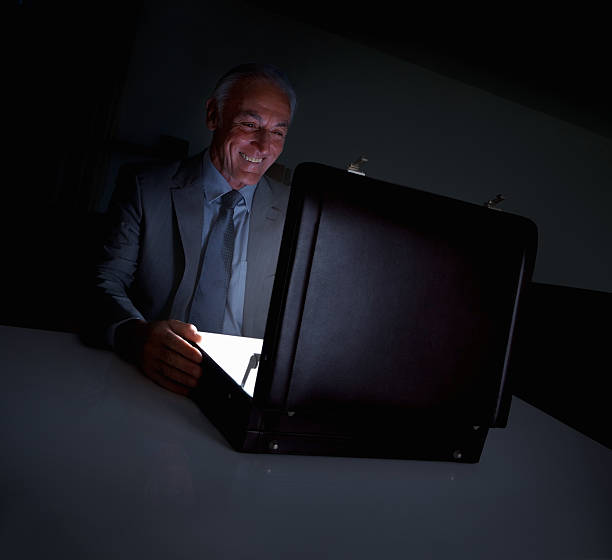 istock Happy business man with a glowing briefcase 184373094