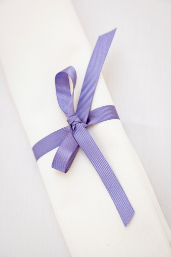 White Cotton Napkin Or Scroll With Lilac Ribbon Bow Stock Photo - Download  Image Now - iStock