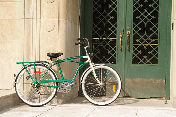 istock Vintage Bicycle Leaning Against Deco Stone Wall and Green Door 184373155